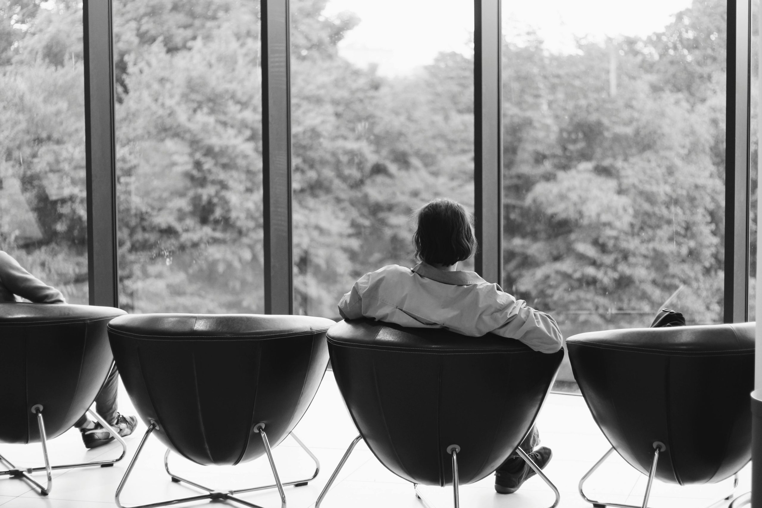 Man in waiting room with view on trees through large windows - Photo by Pawel L - Pexels